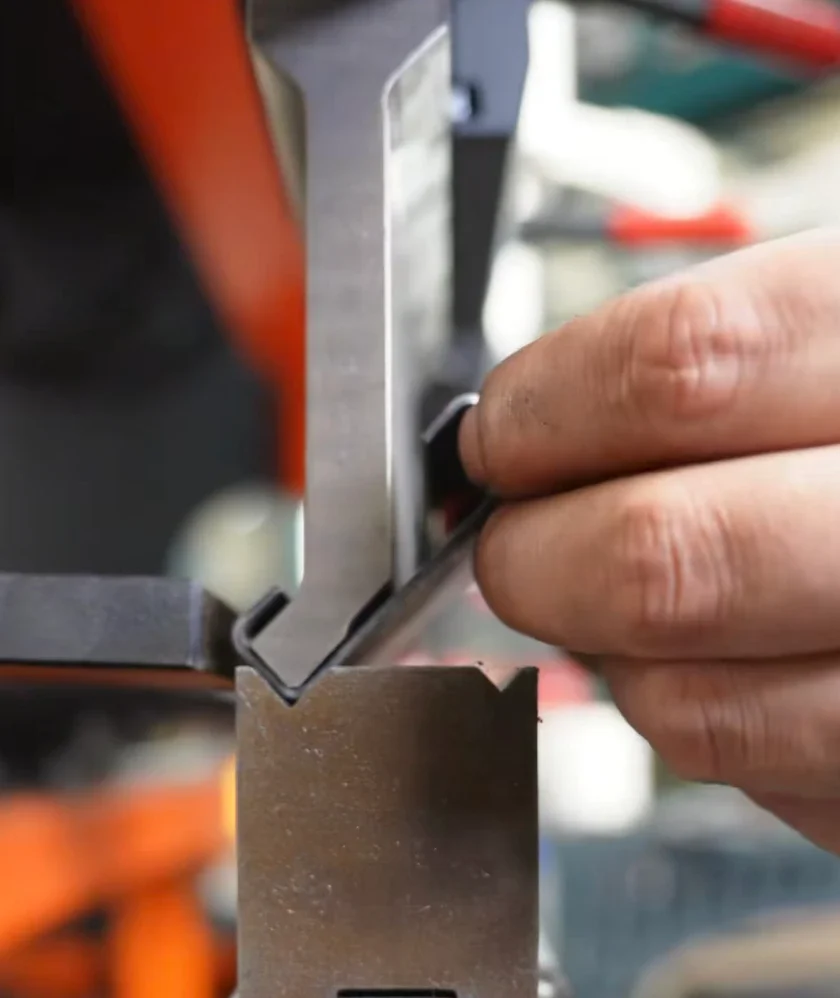 Metal frame profile or return flange bent with a sash punch