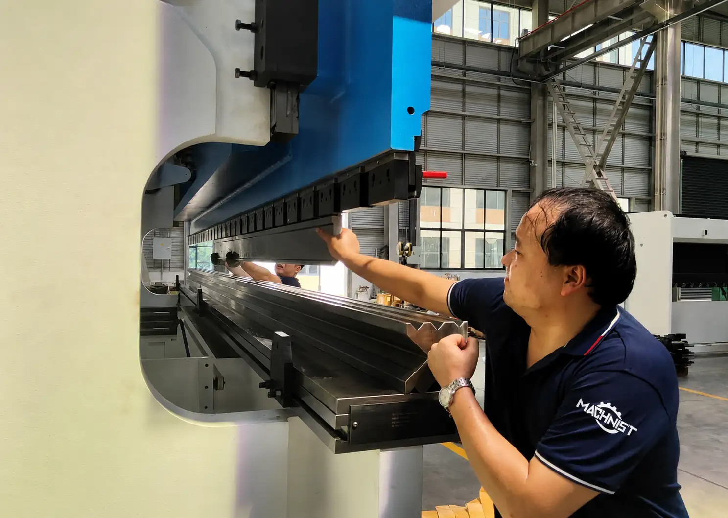 Operator loading heavy press brake die with semi-automatic tooling storage system